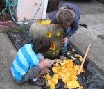 Carving their home-grown pumpkin!
